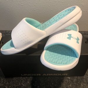 White and teal women’s under armour slides